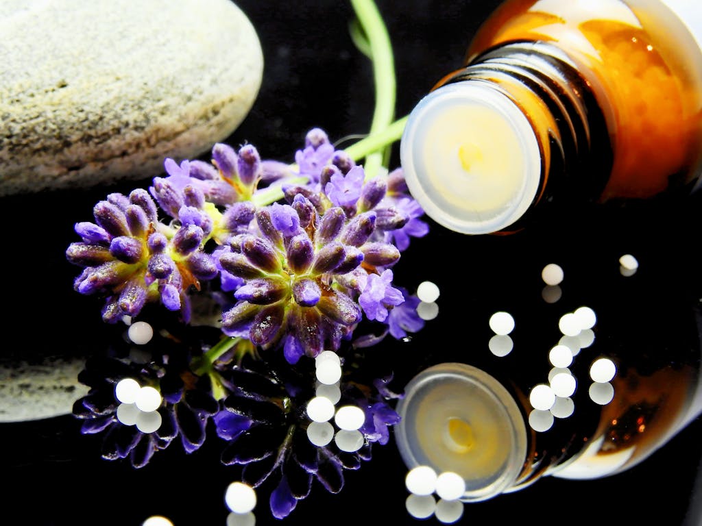 Current image: Lavender flowers with herbal homeopathy on a reflective surface, ideal for natural therapy themes.